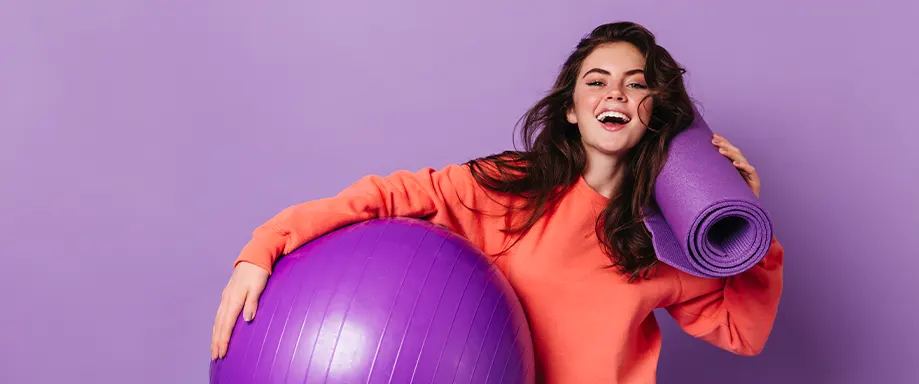 An image of a woman with exercise equipment