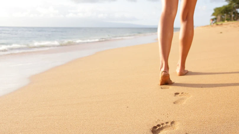 una mujer paseando por la playa