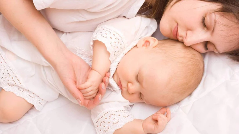 an image of a mother sleeps with a baby