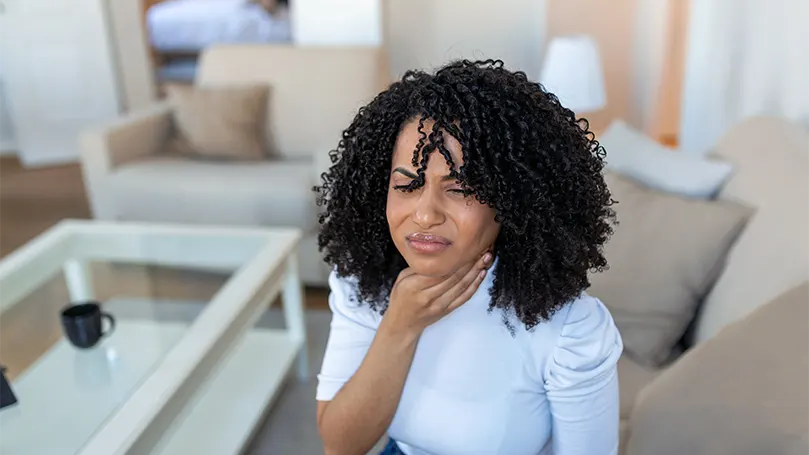 An image of a young woman suffering from acid reflux.