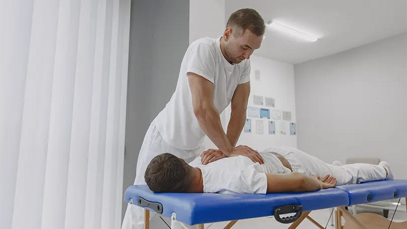 An image of a chiropractic performing a physical therapy.