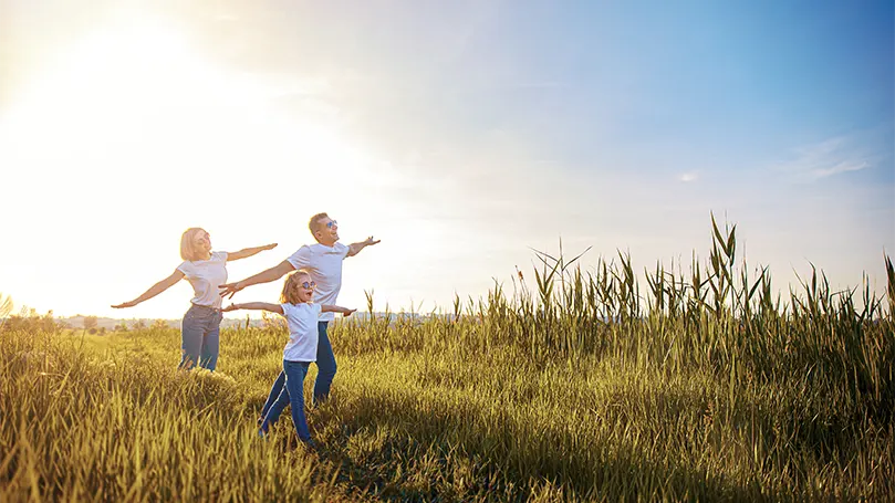 Una imagen de una familia corriendo por el campo