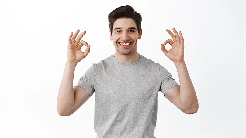 An image of a man shoing an 'ok' sign with his hands.