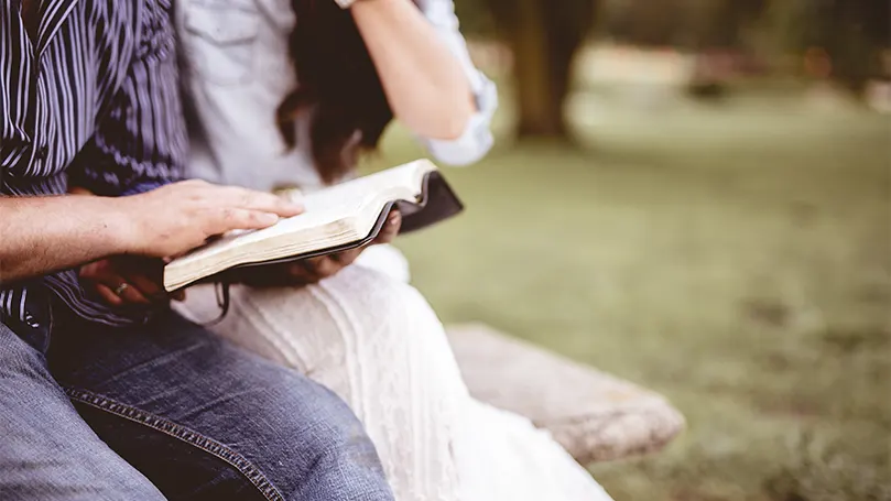 An image of a person reading some religious text