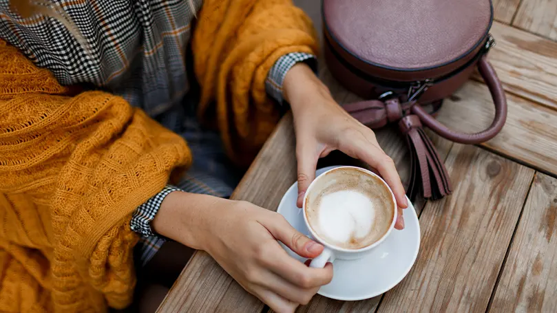 Una imagen de una persona bebiendo café al aire libre