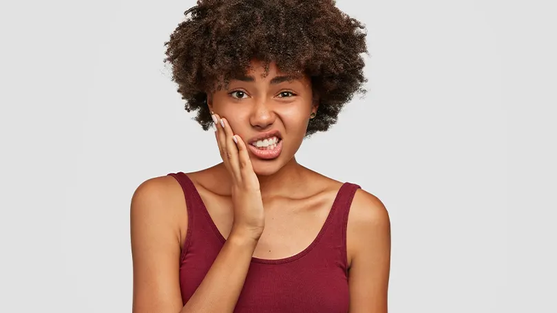 An image of a woman with a toothache.