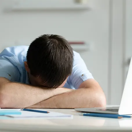 A young man sleeping on table