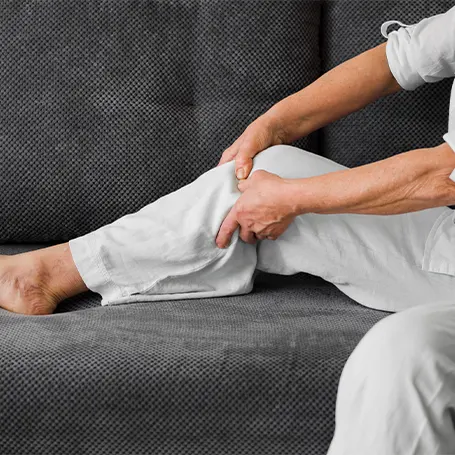 An image of a man touching his knee.